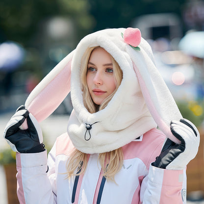 Person wearing a fluffy bunny hood with pink ears outdoors
